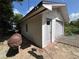 Detached garage with siding and a backyard barbecue grill for outdoor cooking at 816 Casselberry Dr, Lake Wales, FL 33853