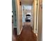 Hallway with modern laminate floors leads to bedrooms and other rooms, providing smooth transition throughout home at 816 Casselberry Dr, Lake Wales, FL 33853