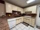 Well-lit kitchen featuring tile floor and cream colored cabinets and drawers at 816 Casselberry Dr, Lake Wales, FL 33853