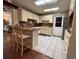 Bright kitchen with white cabinets, tiled floor, and an island with barstool seating at 816 Casselberry Dr, Lake Wales, FL 33853