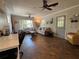 Bright, open living room with comfortable sofas, ceiling fans, natural lighting and workspace with a desk at 816 Casselberry Dr, Lake Wales, FL 33853