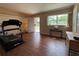 Spacious living room with hardwood floors, natural light, and access to the exterior at 816 Casselberry Dr, Lake Wales, FL 33853