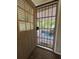 An open patio door welcomes you to a cozy, screened porch for enjoying the outdoors at 816 Casselberry Dr, Lake Wales, FL 33853