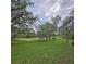 Expansive backyard with lush grass and mature trees, with Spanish moss at 816 Pinewood Ct # 3126, Haines City, FL 33844