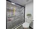Luxurious walk-in shower featuring marble tiling and modern showerhead at 816 Pinewood Ct # 3126, Haines City, FL 33844