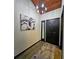 Modern entryway with wood-look floors, bold art, and contemporary light fixture at 816 Pinewood Ct # 3126, Haines City, FL 33844