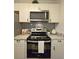 Well-appointed kitchen featuring stainless steel appliances and sleek white cabinetry at 816 Pinewood Ct # 3126, Haines City, FL 33844