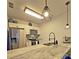 The stylish kitchen features stainless steel appliances and modern pendant lighting at 816 Pinewood Ct # 3126, Haines City, FL 33844