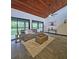Beautiful living space featuring a wood ceiling, modern decor, and sliding glass doors to the patio at 816 Pinewood Ct # 3126, Haines City, FL 33844