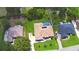 Birds-eye view of the home with solar panels, pool, spacious backyard, and well-kept lawn at 10708 Belo Horizonte Ave, Clermont, FL 34711