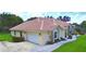 Aerial view of a home with lush lawn, a driveway, and manicured landscaping at 10708 Belo Horizonte Ave, Clermont, FL 34711