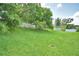 Lush green backyard with mature trees and a partially fenced perimeter at 10708 Belo Horizonte Ave, Clermont, FL 34711