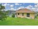 Exterior showcasing the screened-in pool, lawn, and the home's architecture at 10708 Belo Horizonte Ave, Clermont, FL 34711