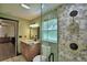 Upgraded bathroom with a stone shower and a marble vanity, plus a view to another room at 10708 Belo Horizonte Ave, Clermont, FL 34711