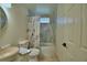 Bright bathroom featuring a stone vessel sink, decor mirror and tiled shower at 10708 Belo Horizonte Ave, Clermont, FL 34711
