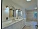 Bathroom with double vanity, marble countertops, and modern lighting at 10708 Belo Horizonte Ave, Clermont, FL 34711
