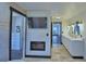 Bathroom showcasing a tub, walk-in closet, fireplace, and double vanity with marble countertops at 10708 Belo Horizonte Ave, Clermont, FL 34711