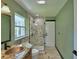 Bathroom features a stone shower, copper sink, marble vanity, and natural light from a window at 10708 Belo Horizonte Ave, Clermont, FL 34711