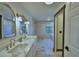 Bathroom featuring a double vanity with marble countertops and modern fixtures at 10708 Belo Horizonte Ave, Clermont, FL 34711