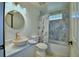 Updated bathroom featuring a stone vessel sink, decorative mirror and tiled shower at 10708 Belo Horizonte Ave, Clermont, FL 34711