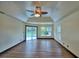 Brightly lit primary bedroom featuring hardwood floors and pool views at 10708 Belo Horizonte Ave, Clermont, FL 34711