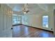 Primary bedroom featuring hardwood floors, ceiling fan, and natural lighting at 10708 Belo Horizonte Ave, Clermont, FL 34711