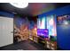 Themed bedroom boasting a mounted TV, space accents and custom cosmic mural at 10708 Belo Horizonte Ave, Clermont, FL 34711