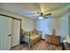 Comfortable bedroom with natural light, wood floors and ceiling fan at 10708 Belo Horizonte Ave, Clermont, FL 34711