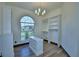 Walk-in closet features custom organizers, a large arched window, and laminate floors at 10708 Belo Horizonte Ave, Clermont, FL 34711