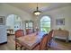 Well-lit dining room featuring a classic chandelier, arch window and dining table with seating for six at 10708 Belo Horizonte Ave, Clermont, FL 34711