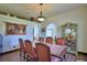 Inviting dining room with an elegant china cabinet, arched doorways, and hardwood floors at 10708 Belo Horizonte Ave, Clermont, FL 34711