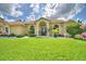 Charming single-story home with a well-manicured lawn and beautiful landscaping at 10708 Belo Horizonte Ave, Clermont, FL 34711