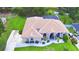Lovely single-story home showcasing meticulous landscaping, a long driveway, and a screened-in pool at 10708 Belo Horizonte Ave, Clermont, FL 34711
