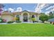 Charming single-story home featuring mature landscaping and impeccable curb appeal at 10708 Belo Horizonte Ave, Clermont, FL 34711