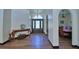 Inviting foyer featuring hardwood floors, an arched doorway, and a clear view into the dining area at 10708 Belo Horizonte Ave, Clermont, FL 34711