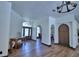 Welcoming foyer with hardwood floors, arched doorways, and a barrel door, offering great flow at 10708 Belo Horizonte Ave, Clermont, FL 34711