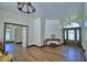 Spacious foyer with hardwood floors, decorative trim, arched doorway, and an elegant chandelier at 10708 Belo Horizonte Ave, Clermont, FL 34711