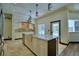 Gourmet kitchen with large island, stone backsplash, and pool views at 10708 Belo Horizonte Ave, Clermont, FL 34711