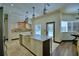 Bright kitchen with an island that features a farmhouse sink, tile flooring, and views of the pool at 10708 Belo Horizonte Ave, Clermont, FL 34711