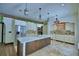 Spacious kitchen with light countertops, stainless steel appliances, and a wooden island at 10708 Belo Horizonte Ave, Clermont, FL 34711