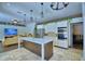 View of a kitchen with a wooden island and an open living room concept at 10708 Belo Horizonte Ave, Clermont, FL 34711
