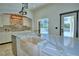 Close up of a kitchen island with light countertops and a farmhouse style sink at 10708 Belo Horizonte Ave, Clermont, FL 34711