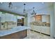 Kitchen featuring a central island with a wooden base, light countertops and modern appliances at 10708 Belo Horizonte Ave, Clermont, FL 34711