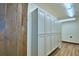 Functional laundry room with bright cabinets and wood-look flooring offers great storage at 10708 Belo Horizonte Ave, Clermont, FL 34711