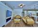 Bright and airy living room boasts a fireplace, television, and elegant couches at 10708 Belo Horizonte Ave, Clermont, FL 34711