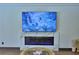 A cozy living room with marble fireplace and mounted television at 10708 Belo Horizonte Ave, Clermont, FL 34711