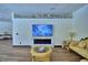 A stunning living room featuring sleek fireplace, modern tv, and decorative shelving at 10708 Belo Horizonte Ave, Clermont, FL 34711