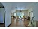 Open living room with hardwood floors, direct access to the pool area, and vintage furniture at 10708 Belo Horizonte Ave, Clermont, FL 34711