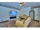 Elegant living room features a modern fireplace, large screen TV and stylish furnishings at 10708 Belo Horizonte Ave, Clermont, FL 34711