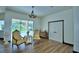 Bright living room featuring hardwood floors, a chandelier, and sliding glass doors to the pool area at 10708 Belo Horizonte Ave, Clermont, FL 34711